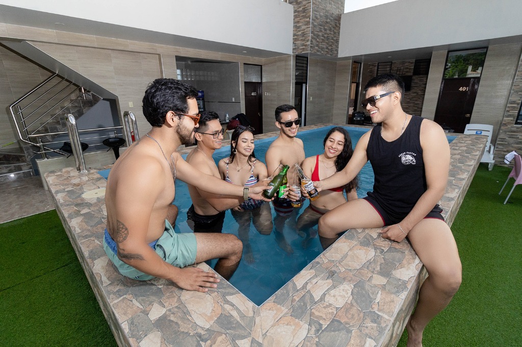 Huéspedes y amigos brindando y disfrutando en la piscina